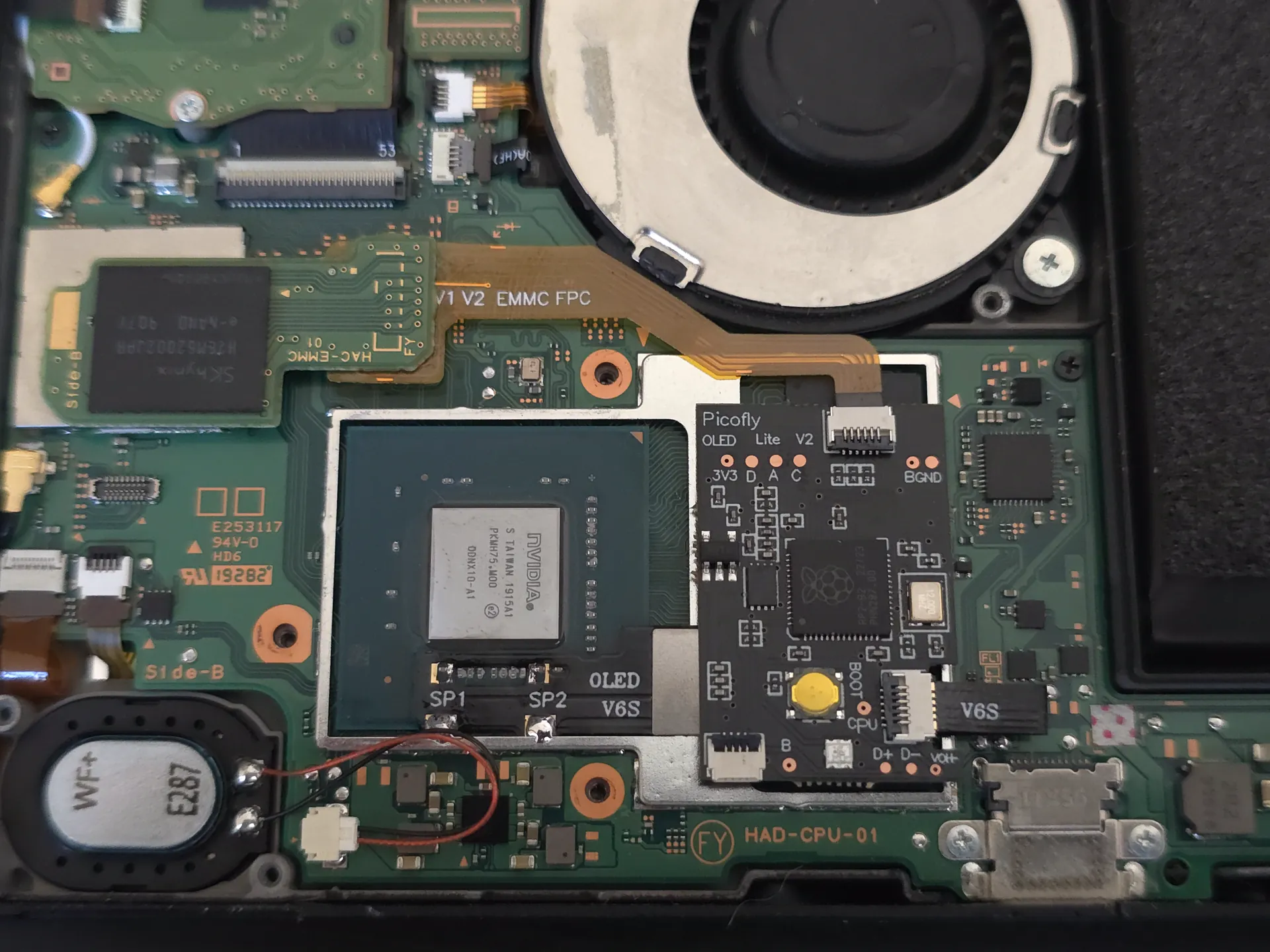 A PicoFly modchip installed beside the APU on a Nintendo Switch V2 mainboard